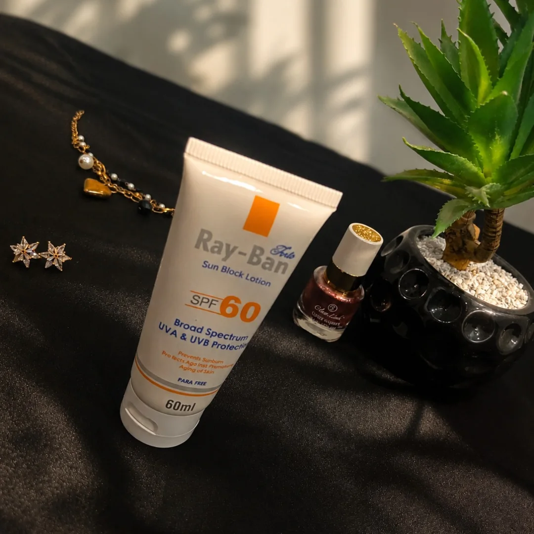 Sunblock lotion with jewellery beside aloe plant